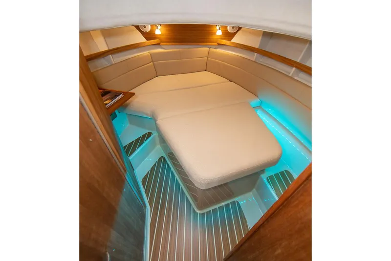 Slide: The Image of Manufacturer Provided Image: 2025 Ranger Tugs R-31 CB cabin with cozy seating and ambient lighting. - 19