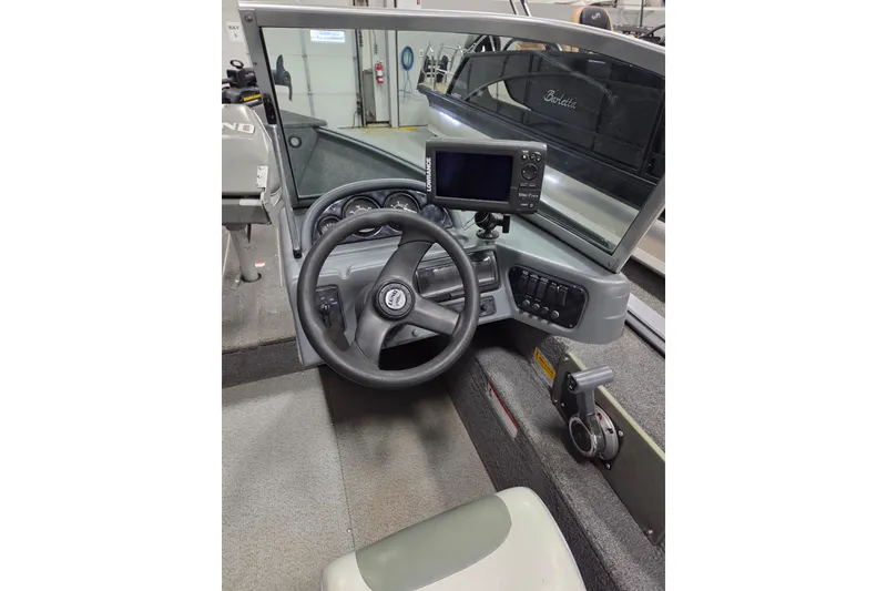 Slide: The Image of 2006 Lund 1775 Classic Sport boat dashboard with steering wheel and navigation system. - 10