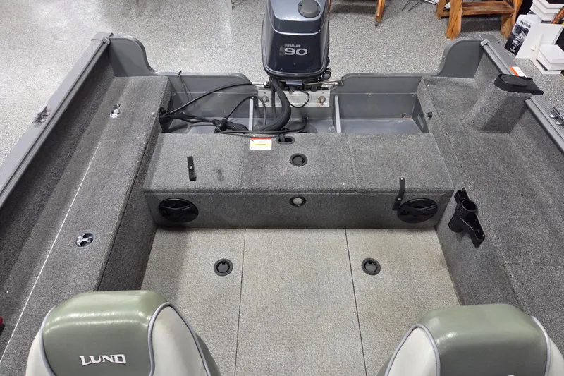 Slide: The Image of 2006 Lund 1775 Classic Sport boat interior with Yamaha 90 engine, gray carpeted deck. - 12