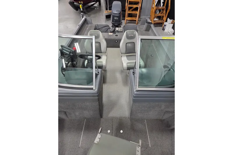 Slide: The Image of 2006 Lund 1775 Classic Sport boat interior with seating and steering console. - 9