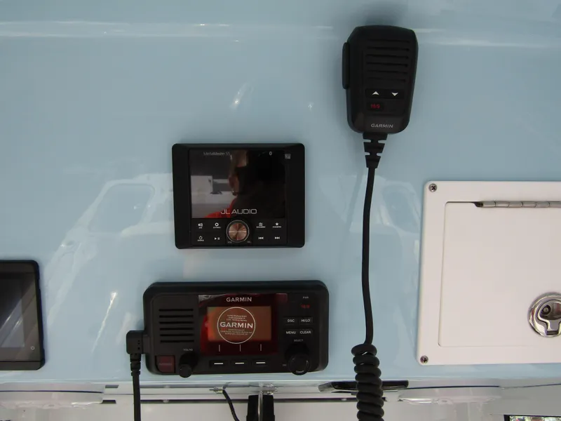 Slide: The Image of 2025 Wellcraft 243 Fisherman dashboard with Garmin marine electronics and audio system. - 25