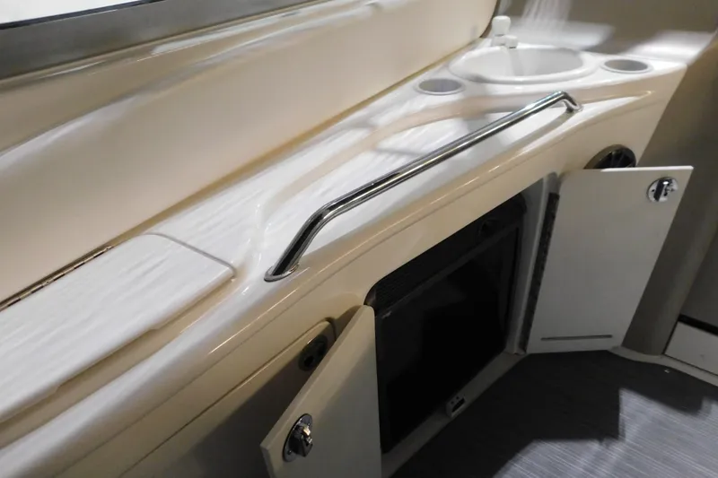 Slide: The Image of 2002 Sea Ray 340 Sundancer interior with sink and storage cabinets. - 10