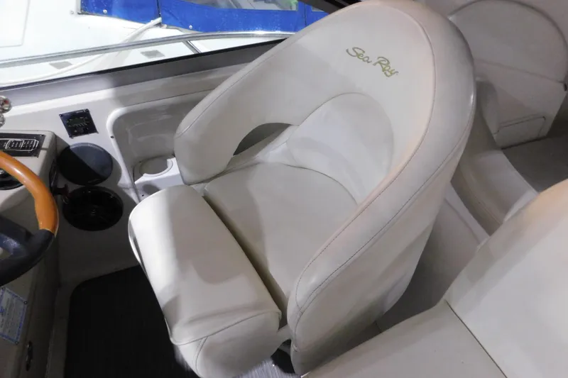 Slide: The Image of Captain's seat of 2002 Sea Ray 340 Sundancer boat, featuring white leather upholstery. - 13