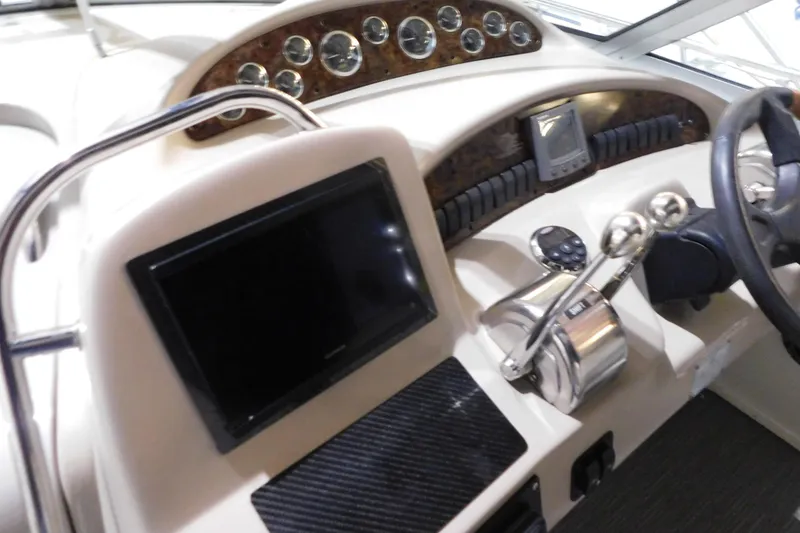 Slide: The Image of 2002 Sea Ray 340 Sundancer helm with gauges, controls, and navigation equipment. - 15