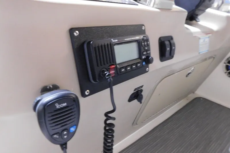 Slide: The Image of Control panel of a 2002 Sea Ray 340 Sundancer boat with Icom radio equipment. - 16
