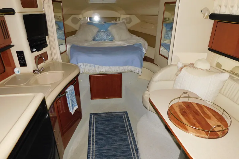 Slide: The Image of Luxurious interior of 2002 Sea Ray 340 Sundancer yacht with cozy bed and kitchenette. - 19