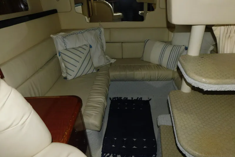 Slide: The Image of Interior of 2002 Sea Ray 340 Sundancer with beige seating and decorative pillows. - 20