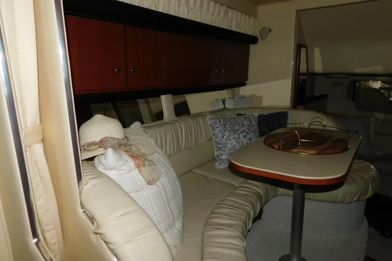 Slide: The Image of Interior of 2002 Sea Ray 340 Sundancer with cozy seating and table. - 23