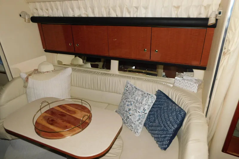 Slide: The Image of Interior of 2002 Sea Ray 340 Sundancer with cozy seating and decorative pillows. - 27