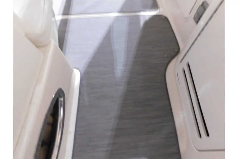 Slide: The Image of Interior view of 2002 Sea Ray 340 Sundancer boat, featuring sleek flooring and cabinetry. - 28
