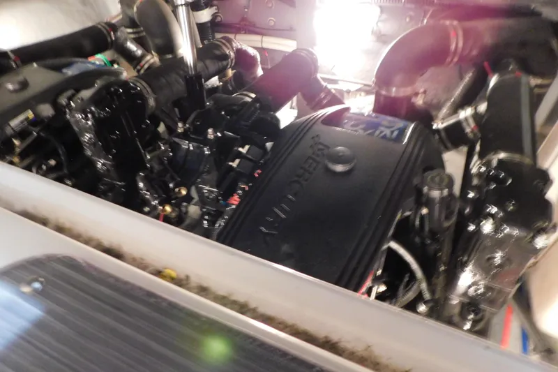 Slide: The Image of Engine compartment of a 2002 Sea Ray 340 Sundancer boat, showcasing mechanical components. - 32