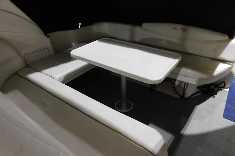 Slide: The Image of Interior seating area of 2002 Sea Ray 340 Sundancer with table and cushioned benches. - 5