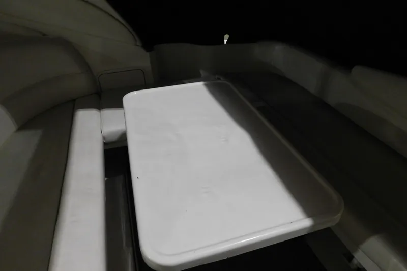 Slide: The Image of 2002 Sea Ray 340 Sundancer interior with white seating and table. - 7