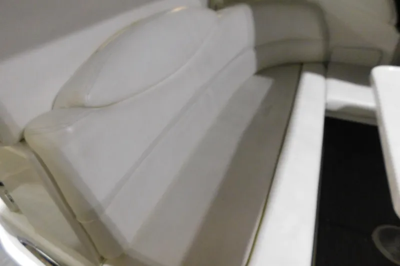 Slide: The Image of 2002 Sea Ray 340 Sundancer interior seating with white upholstery. - 8