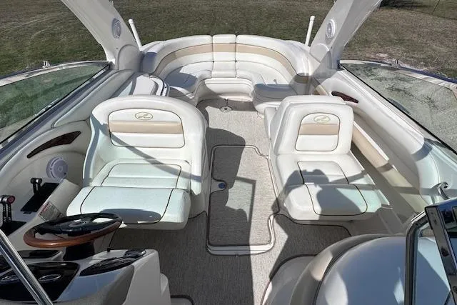 Slide: The Image of 2001 Sea Ray 290 Bowrider interior with white seating and spacious layout. - 16