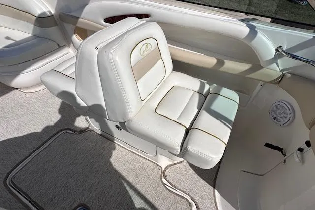 Slide: The Image of 2001 Sea Ray 290 Bowrider interior with white leather seating and carpeted flooring. - 18