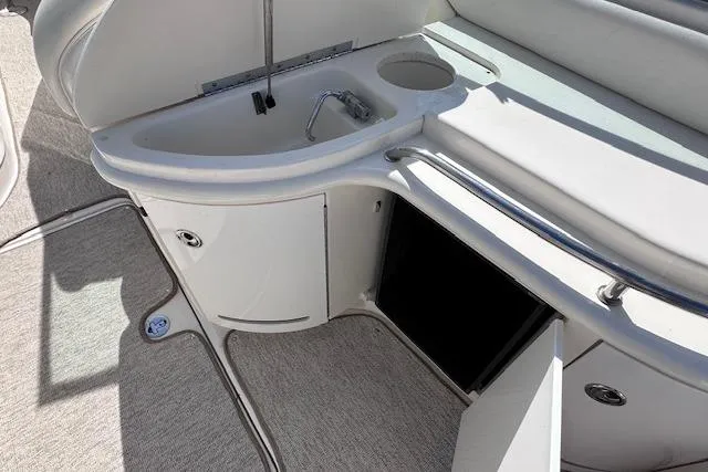 Slide: The Image of 2001 Sea Ray 290 Bowrider interior with sink and storage compartments. - 20