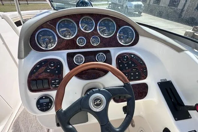 Slide: The Image of 2001 Sea Ray 290 Bowrider dashboard with gauges and steering wheel. - 21