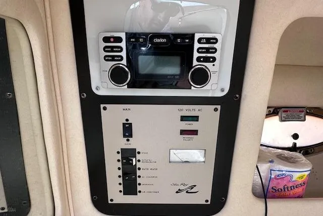 Slide: The Image of 2001 Sea Ray 290 Bowrider control panel with Clarion stereo and electrical switches. - 24