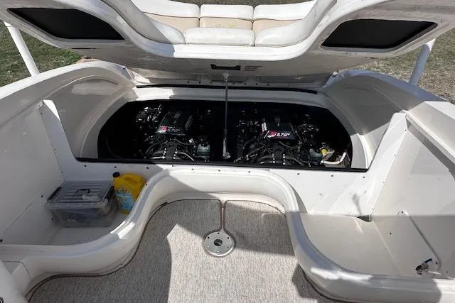 Slide: The Image of 2001 Sea Ray 290 Bowrider engine compartment with dual engines and storage space. - 26