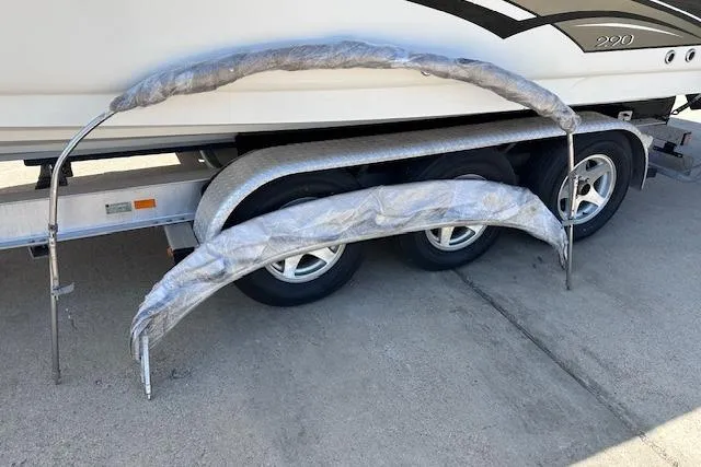 Slide: The Image of 2001 Sea Ray 290 Bowrider on trailer with wrapped metal frames. - 32