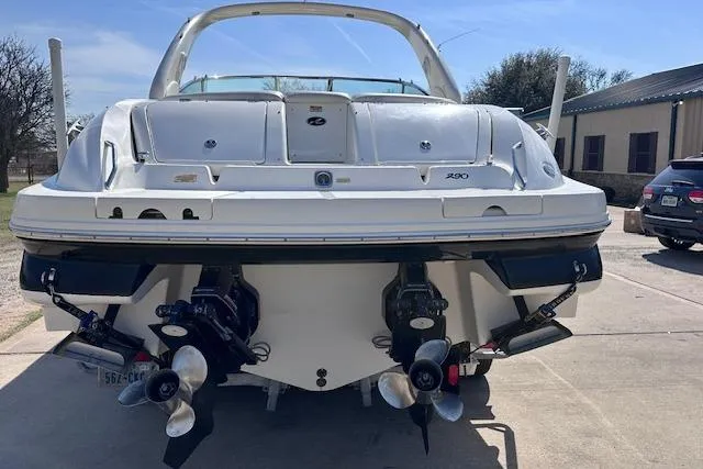 Slide: The Image of 2001 Sea Ray 290 Bowrider boat, rear view with dual propellers, parked outdoors. - 8