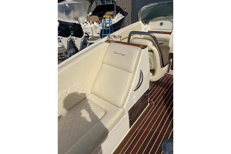 Slide: The Image of 2017 Chris-Craft Corsair 32 boat interior with cream leather seating and wood accents. - 12