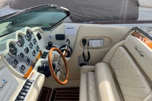 Slide: The Image of 2017 Chris-Craft Corsair 32 cockpit with leather seats and wooden steering wheel. - 17