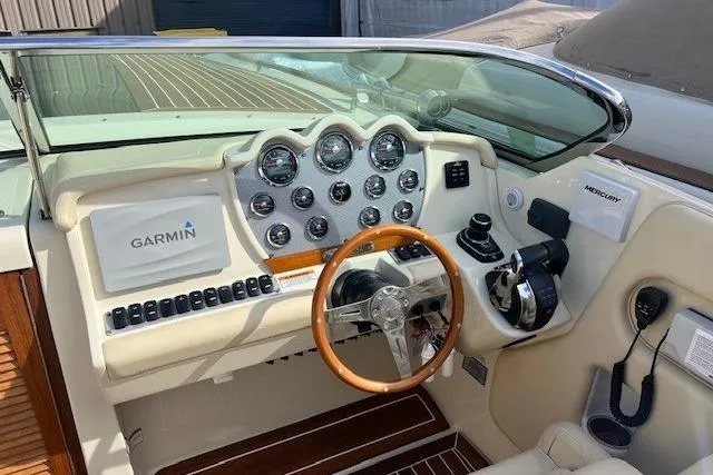 Slide: The Image of 2017 Chris-Craft Corsair 32 boat dashboard with Garmin navigation and wooden steering wheel. - 18