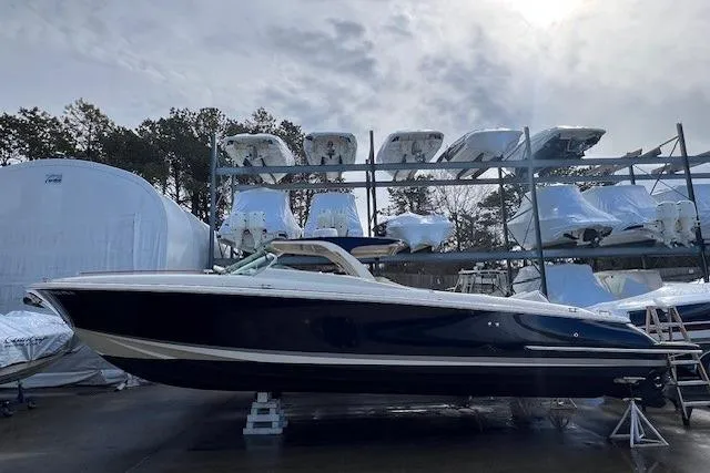Slide: The Image of 2017 Chris-Craft Corsair 32 boat in storage, surrounded by other vessels. - 2