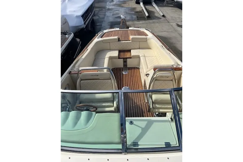 Slide: The Image of 2017 Chris-Craft Corsair 32 boat interior with luxurious seating and wood accents. - 20