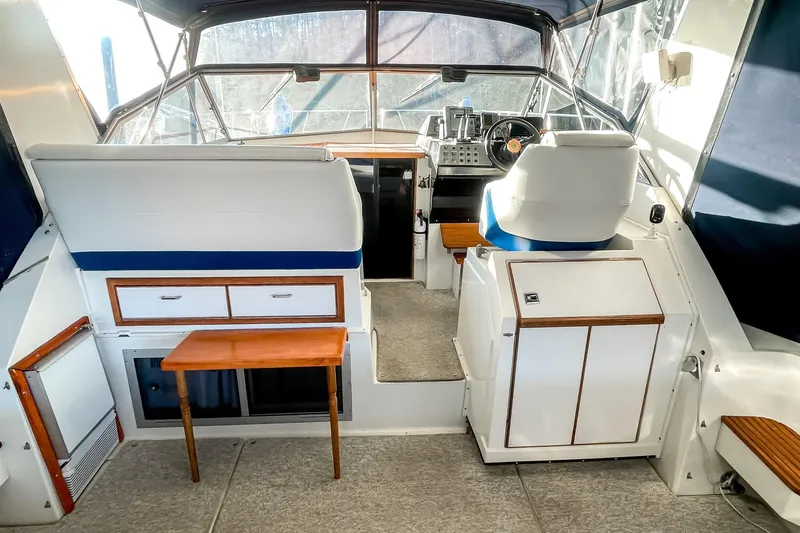 Slide: The Image of Interior of a 1990 Carver 32 Montego boat with seating and control panel. - 11