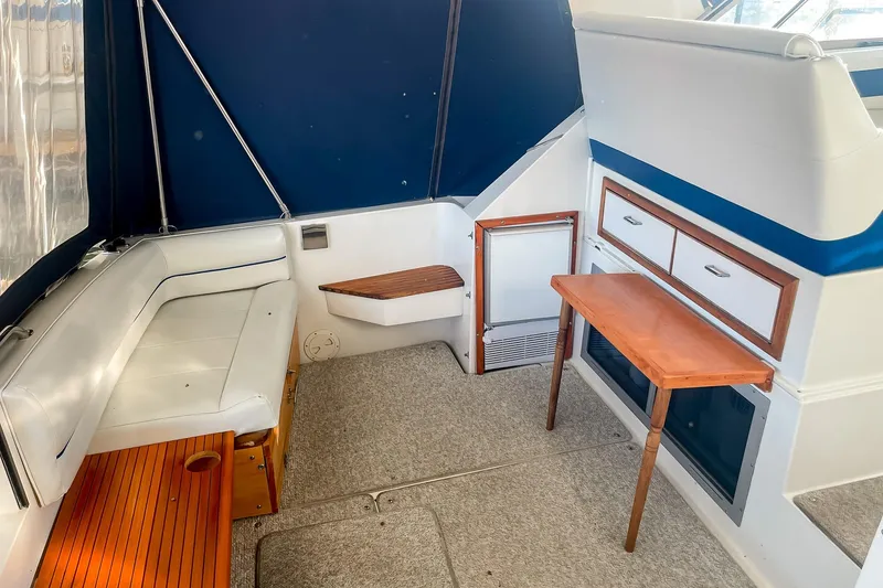 Slide: The Image of Interior of 1990 Carver 32 Montego boat with seating, table, and storage. - 16