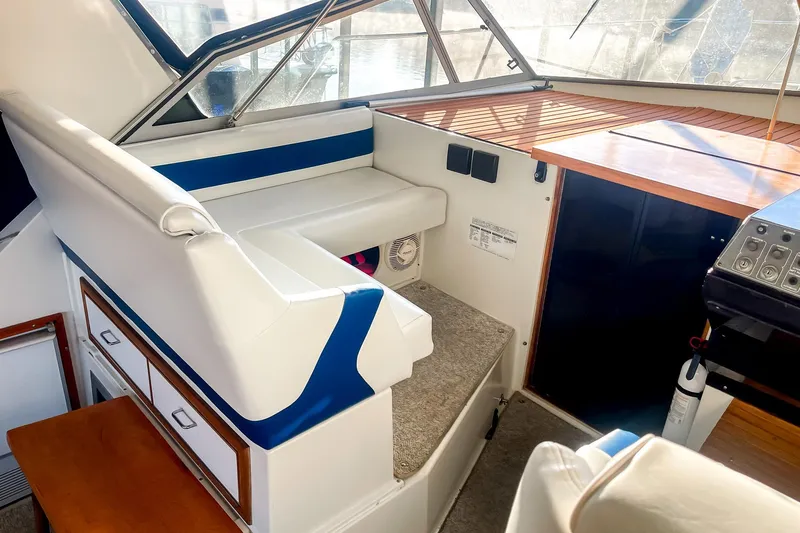 Slide: The Image of Interior of a 1990 Carver 32 Montego boat with seating and control panel. - 19