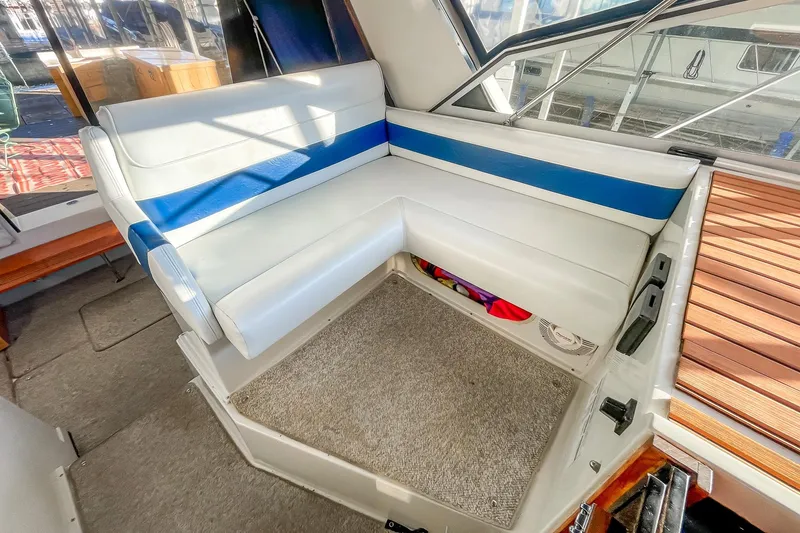 Slide: The Image of Interior seating of 1990 Carver 32 Montego boat with white and blue upholstery. - 20