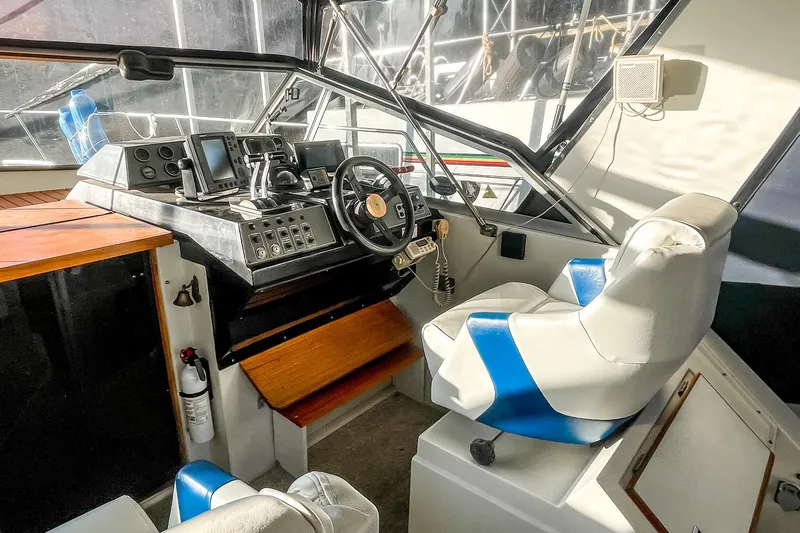 Slide: The Image of Interior helm of 1990 Carver 32 Montego boat with navigation equipment and captain's chair. - 23