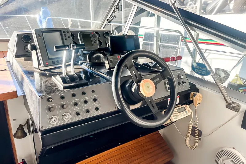 Slide: The Image of 1990 Carver 32 Montego helm with navigation equipment and steering wheel. - 24