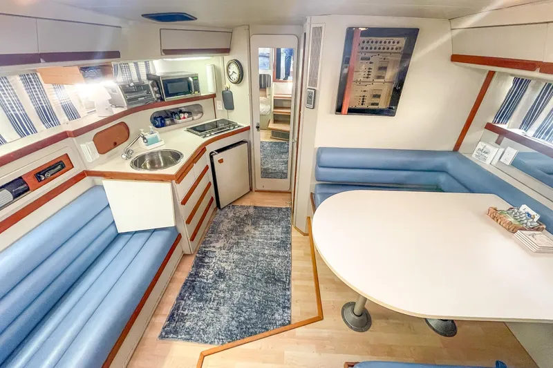 Slide: The Image of Interior of 1990 Carver 32 Montego yacht with kitchen and dining area. - 27