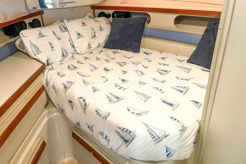 Slide: The Image of Cozy cabin bed in 1990 Carver 32 Montego yacht with nautical-themed bedding. - 30