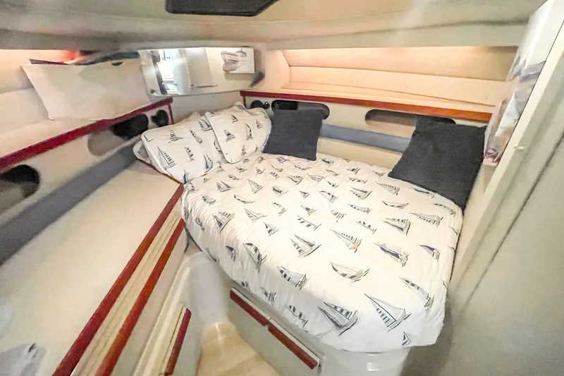Slide: The Image of Cozy cabin interior of 1990 Carver 32 Montego with nautical-themed bedding. - 31