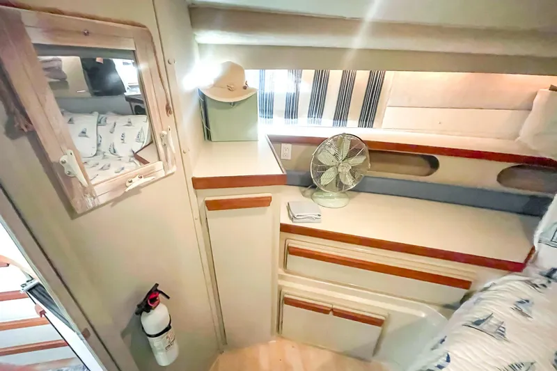 Slide: The Image of Interior of 1990 Carver 32 Montego boat with cozy cabin and nautical decor. - 32