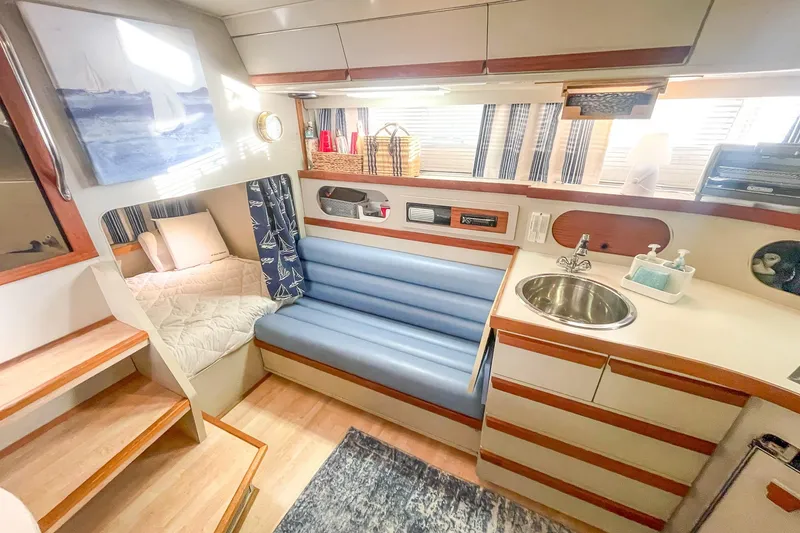 Slide: The Image of Interior of 1990 Carver 32 Montego yacht with cozy seating and kitchenette. - 37