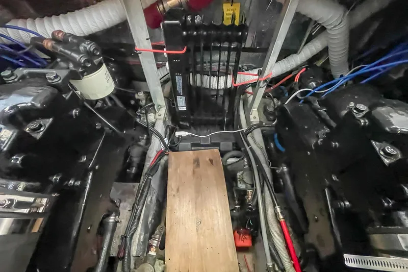 Slide: The Image of Engine room of a 1990 Carver 32 Montego boat, showcasing mechanical components and wiring. - 39