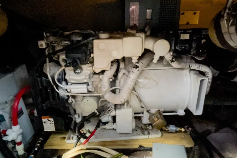 Slide: The Image of Engine compartment of a 1990 Carver 32 Montego boat, showcasing mechanical components. - 42