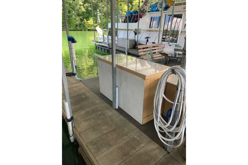 Slide: The Image of Dockside view with Carver 32 Montego, 1990 model, moored near lush greenery. - 43