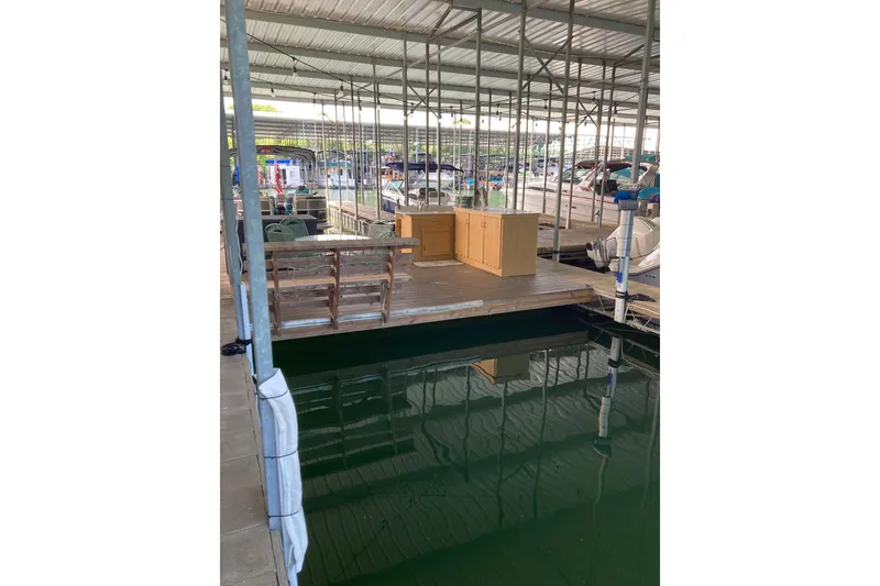 Slide: The Image of Covered marina dock with Carver 32 Montego, 1990 model, and wooden furniture. - 44