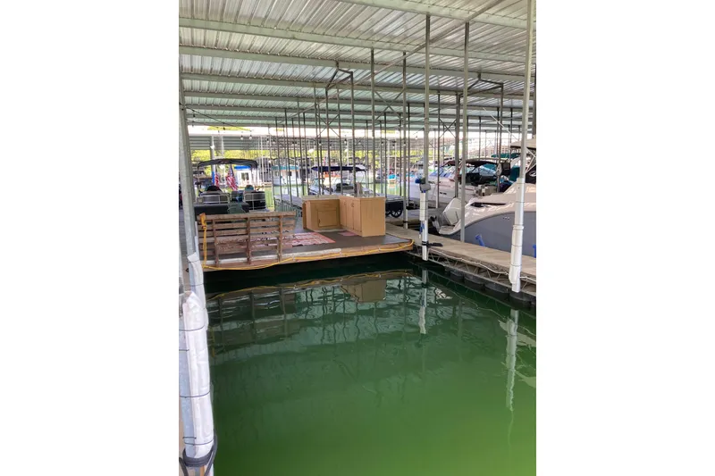 Slide: The Image of Covered marina with boats, featuring a 1990 Carver 32 Montego. - 46