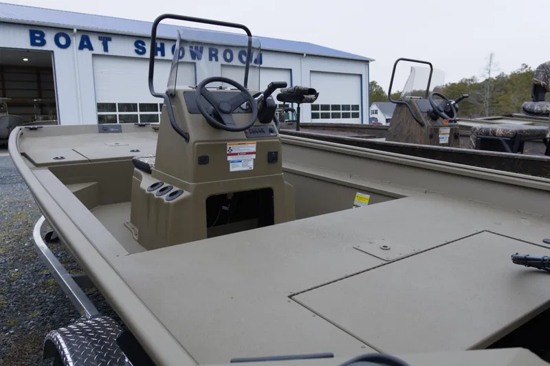 Slide: The Image of 2026 G3 Gator Tough 17 CC boat displayed at a showroom, highlighting its steering console. - 4