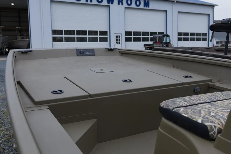 Slide: The Image of 2026 G3 Gator Tough 17 CC boat in showroom, featuring spacious deck and camo seating. - 5
