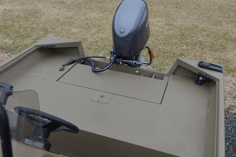 Slide: The Image of 2026 G3 Gator Tough 17 CC boat with outboard motor on grassy area. - 7